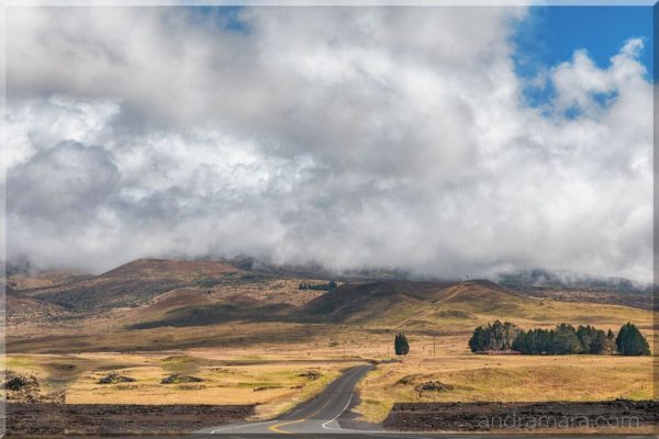 Road meanders through the clouds gathering before a storm