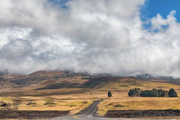 Road meanders through the clouds gathering before a storm