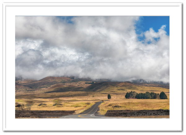 Road meanders through the clouds gathering before a storm