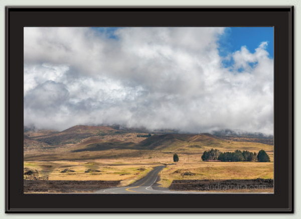 Road meanders through the clouds gathering before a storm